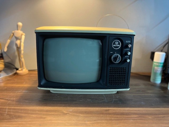 Cream 1980s vintage CRT television with side dials to hire