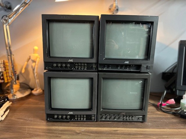 Stack of four vintage JVC CRT monitors for hire