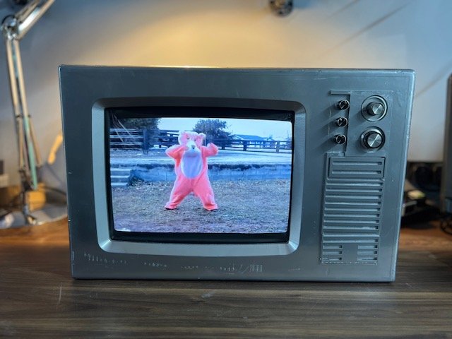 Dark grey retro TV to hire playing a music video