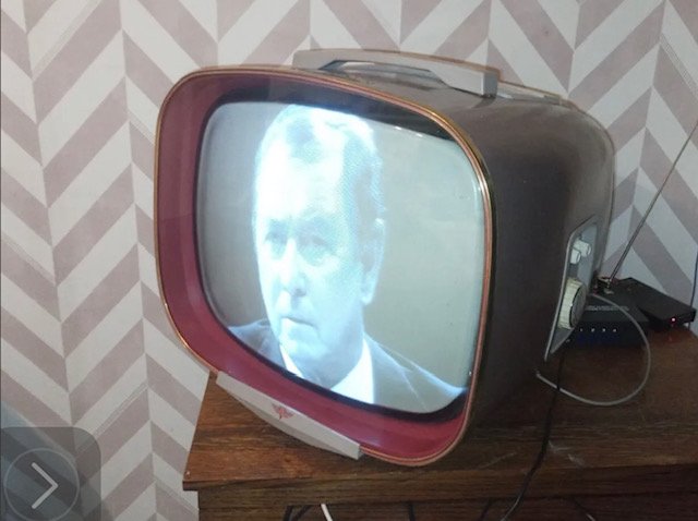 1950s vintage television with rounded screen playing footage to hire