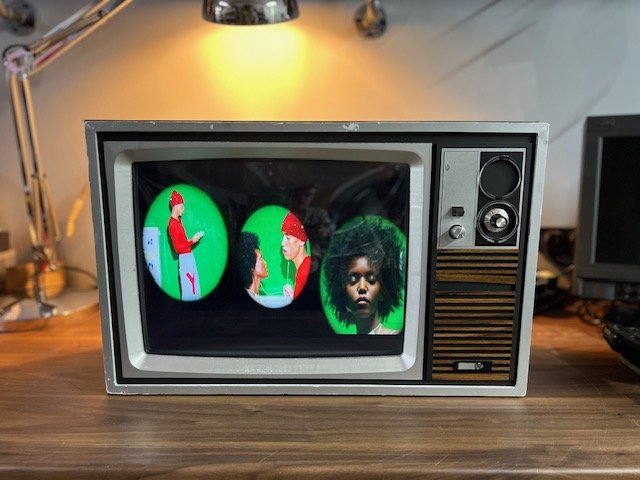 Silver and wood retro television for hire playing video content