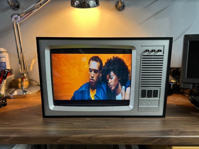 Silver vintage television playing music video to hire