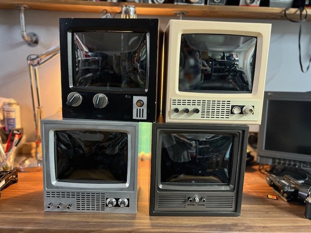 Stack of four small vintage retro TVs for hire