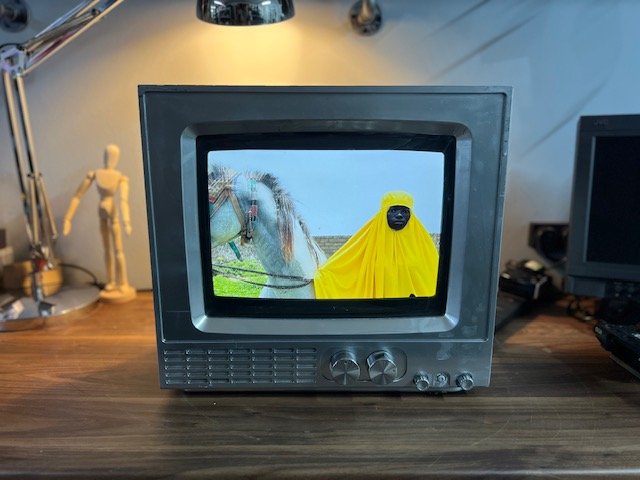 Grey retro CRT TV for hire playing a short film