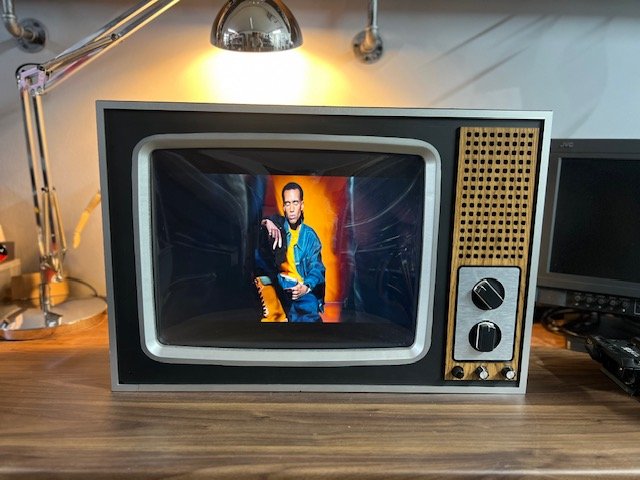 Grey retro CRT television with perforated speaker to hire