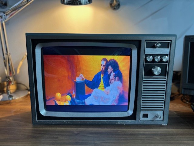 Black retro TV with control panel for hire playing video