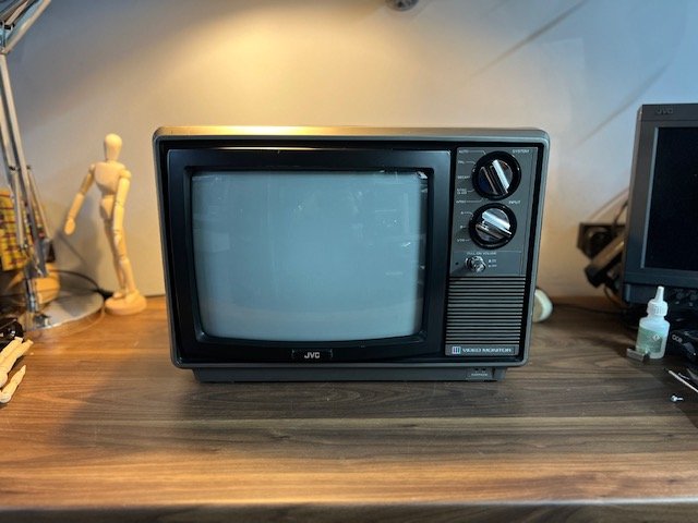 Small black 1980s portable CRT TV to hire with control knob