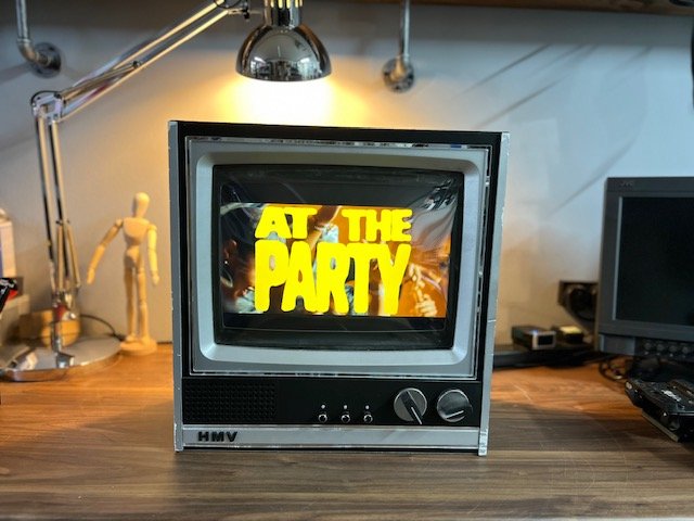 Black retro CRT TV for hire playing branded video content