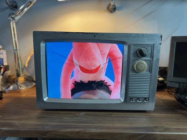 Retro CRT television for hire with bright music video on screen